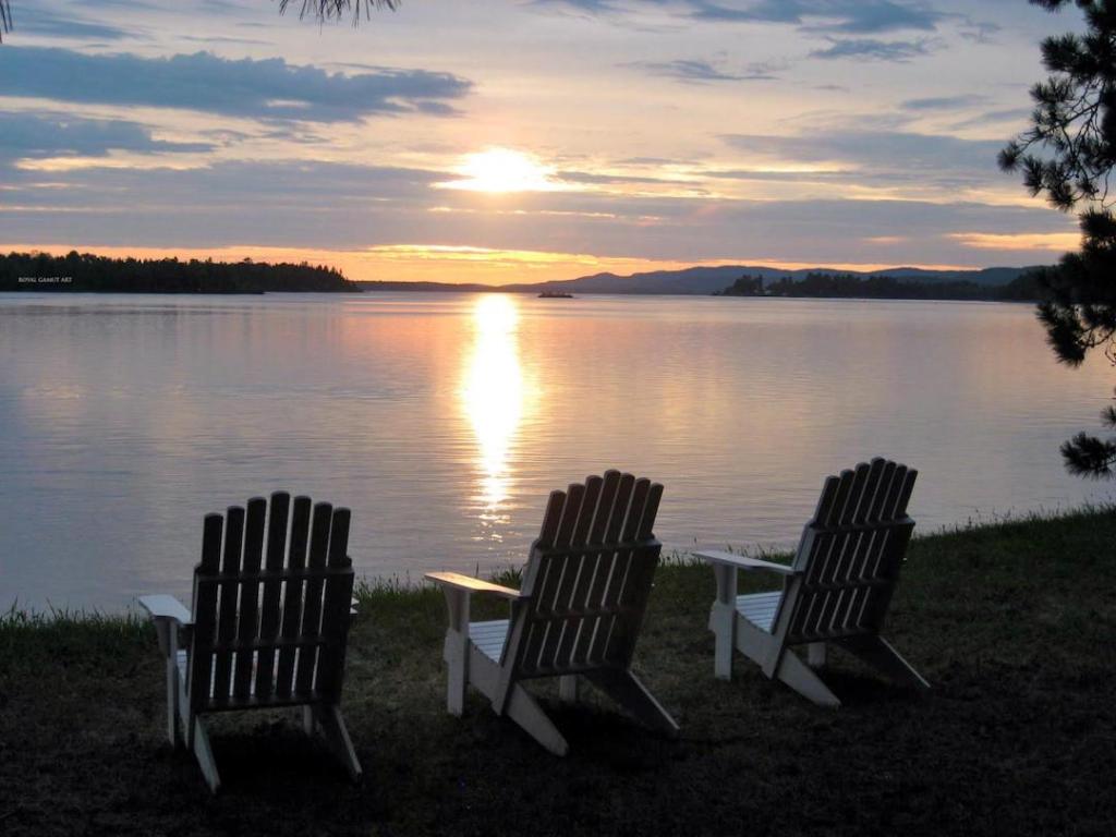 Empty Chairs for loved ones on the Ottawa river at sunset.